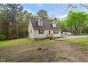 Quaint single-Gathering home nestled amongst mature trees with a well-manicured lawn at 2603 Brogden Rd, Creedmoor, NC 27522
