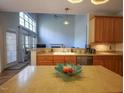 Open-concept kitchen featuring a large island and a view into the adjacent living room at 2932 Candlehurst Ln, Raleigh, NC 27616