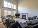 Spacious living room with a fireplace, large windows, and comfortable seating at 2932 Candlehurst Ln, Raleigh, NC 27616