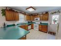Functional kitchen features wood cabinets, white appliances, and solid surface countertops at 30 Shannon Rd, Timberlake, NC 27583
