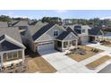 Aerial view of single-Gathering home featuring a covered porch, two-car garage, and landscaped yard at 301 Crayton Oak Dr, Cary, NC 27519