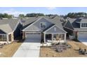 Charming single-Gathering home with a covered porch, two-car garage, well-manicured lawn, and neutral color palette at 301 Crayton Oak Dr, Cary, NC 27519