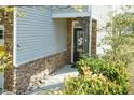 The front entrance features stone accents, a black front door, and manicured landscaping at 3011 September Dr, Durham, NC 27703