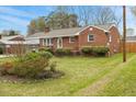 View of a well-maintained lawn and landscaped garden highlighting the home's exterior at 324 Dare St, Burlington, NC 27217