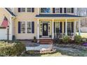 Charming front porch with rocking chairs, decorative plants, and an inviting entrance at 3424 English Cir, Willow Springs, NC 27592