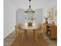 Elegant dining room with a modern chandelier, wood table, and stylish decor at 3533 N Way Dr, Zebulon, NC 27597