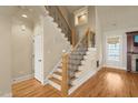 Elegant foyer with hardwood floors, decorative staircase, and natural light, creating an inviting entrance at 367 Windham Way, Clayton, NC 27527