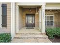 Inviting front porch with stone accents, columns, and a decorative front door, creating a warm welcome at 367 Windham Way, Clayton, NC 27527
