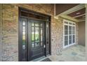 Detailed view of the front door with sidelights and stone facade, showcasing quality craftsmanship at 367 Windham Way, Clayton, NC 27527