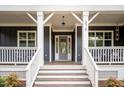Charming front porch with stairs, wooden deck, and cozy seating area at 370 Chapel Ridge Dr, Pittsboro, NC 27312