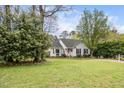 Well-maintained home with lush lawn, mature trees, and neatly trimmed landscaping, creating a welcoming curb appeal at 3708 Turnbull Ct, Raleigh, NC 27616