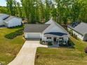 Aerial view of a well maintained home with green lawns and landscaping in a quiet residential neighborhood at 374 Ashley Woods Ct, Clayton, NC 27527