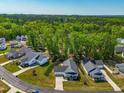 A high angle view of a neighborhood with tree lined streets and well-manicured lawns at 374 Ashley Woods Ct, Clayton, NC 27527