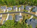 An aerial view shows an orderly neighborhood with manicured lawns, tree-lined streets, and well-maintained homes at 374 Ashley Woods Ct, Clayton, NC 27527
