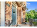 Charming front door with decorative wreath, enhancing the brick facade and cozy entryway at 4 Scottish Ln, Durham, NC 27707