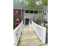 Exterior of condo featuring a latticework balcony and a white picket fence at 411 Gooseneck Drive # B6, Cary, NC 27513