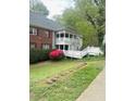 Condo exterior features latticework balcony, white picket fence, and well maintained lawn at 411 Gooseneck Drive # B6, Cary, NC 27513