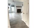 Bright living room with hardwood floors, fireplace, and a door leading to the outside at 411 Gooseneck Drive # B6, Cary, NC 27513