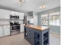 A well-equipped kitchen featuring stainless steel appliances, a kitchen island, and abundant counter space at 5 Maidenhair Ct, Durham, NC 27703