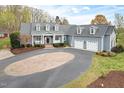Charming home features a welcoming front entrance and three-car garage at 500 Walnut Hill Dr, Hillsborough, NC 27278