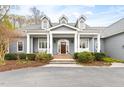 Inviting front porch with classic columns and meticulous landscaping at 500 Walnut Hill Dr, Hillsborough, NC 27278