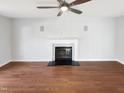 Spacious living room features hardwood floors, a fireplace with white mantle, and a ceiling fan at 5005 Baywood Forest Dr, Knightdale, NC 27545