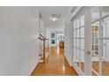 Bright foyer boasts hardwood floors, a staircase, and glass-paneled doors, creating a welcoming entrance at 5033 Homeplace Dr, Apex, NC 27539