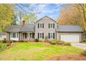 Charming two-story home with gray siding, black shutters, attached garage and landscaped front yard at 516 Edinburgh Dr, Burlington, NC 27215