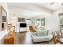 Open-concept living room with hardwood floors, neutral walls, and ample natural light from large windows at 5551 Vista View Ct, Raleigh, NC 27612