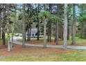 View of the house down the wooded driveway at 5578 Tabbs Creek Church Rd, Oxford, NC 27565