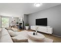 Bright living room features a fireplace, ceiling fan, neutral walls, and modern decor at 58 Stoneridge Rd, Durham, NC 27705