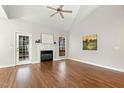 Spacious living room featuring vaulted ceilings, hardwood floors, a fireplace, and natural light from windows at 605 Lakeview Ave, Wake Forest, NC 27587
