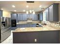 Spacious kitchen features granite countertops, stainless steel appliances and painted cabinets at 6705 Somerknoll Dr, Durham, NC 27713