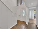 Inviting foyer with hardwood and tile floors, complemented by natural light from the front door at 717 E Millbrook Rd, Raleigh, NC 27609