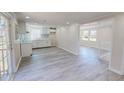 Bright, open-concept kitchen and living area with new flooring and fresh paint at 72 Edgemont Ave, Roxboro, NC 27573