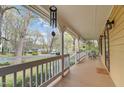Inviting porch features a wood deck, white railings, and a serene neighborhood view at 7317 Mill Ridge Rd, Raleigh, NC 27613