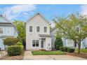 Exterior showcasing a two-story home with white siding, a well-kept lawn, and a paved walkway at 7819 Acc Blvd, Raleigh, NC 27612