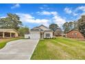 Attractive one-story home with a well-manicured lawn, a one-car garage, and white vinyl siding at 8 Nottingham Pl, Smithfield, NC 27577