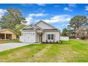 Beautiful one-story home with a well-maintained lawn, white siding, and inviting curb appeal at 8 Nottingham Pl, Smithfield, NC 27577