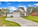 Lovely single-story house with a one-car garage, landscaped yard, and concrete driveway at 8 Nottingham Pl, Smithfield, NC 27577