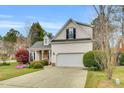 Charming home featuring a manicured lawn, two car garage, and architectural roof at 801 Noconia Pl, Fuquay Varina, NC 27526