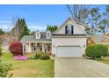 Charming home featuring a manicured lawn, two car garage, and architectural roof at 801 Noconia Pl, Fuquay Varina, NC 27526