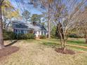 Charming brick home with blue shutters, well-manicured lawn, and a welcoming brick walkway at 806 S First St, Smithfield, NC 27577