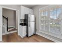 Eat-in kitchen features stainless steel refrigerator and a window overlooking the backyard at 8700 Leeds Forest Ln, Raleigh, NC 27615