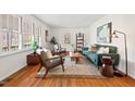 Bright living room featuring hardwood floors, a large window, and tastefully coordinated modern furniture at 927 Ferncrest Dr, Durham, NC 27705