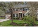 Lovely home with blooming bushes, dark shutters, and a well-maintained front lawn at 102 Swallow Hill Ct, Cary, NC 27513