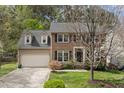 Beautiful two-story home featuring brick accents, a driveway, and a lush green lawn at 102 Swallow Hill Ct, Cary, NC 27513