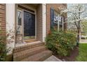 Close-up of an elegant front door with brick steps and decorative sidelights at 102 Swallow Hill Ct, Cary, NC 27513