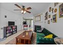 Inviting living room with ceiling fan, fireplace and view into kitchen at 103 Friar Ln, Carrboro, NC 27510