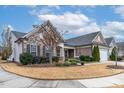 Attractive home with stone and siding, manicured landscaping, and a welcoming front porch at 103 Tanoak Ct, Durham, NC 27703